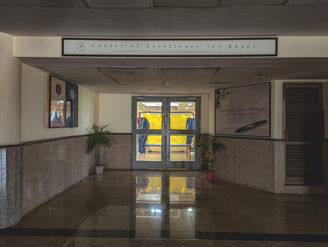 Gateway to Tradition: The formal entrance foyer to the Center of Excellence for Khadi, where polished granite surfaces and clear signage establish a professional tone for this hub of textile innovation.