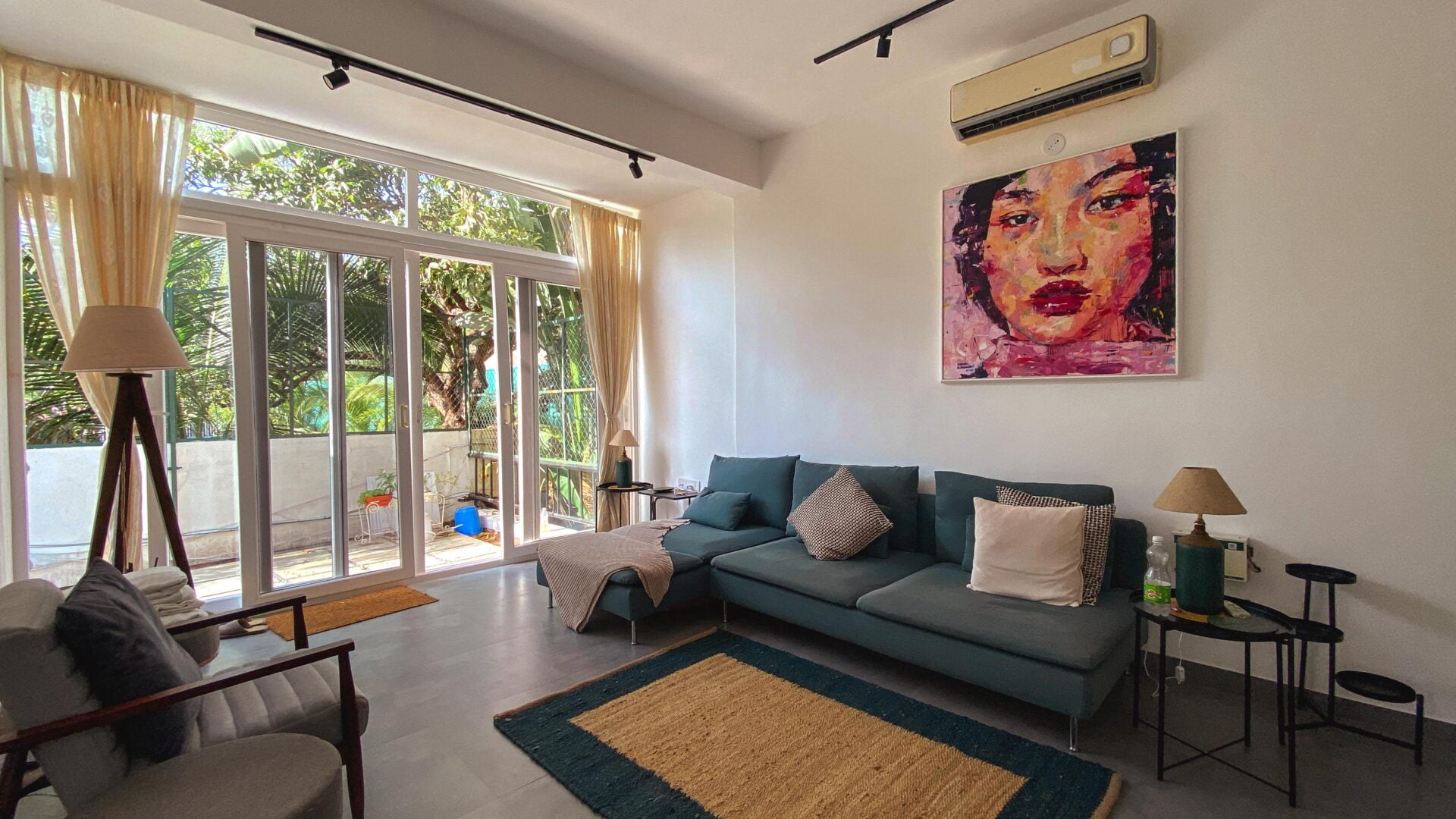 Modern coastal living: This sun-lit apartment in Anjuna blends neutral grey tones with bold colors and opens up to lush tropical greenery.