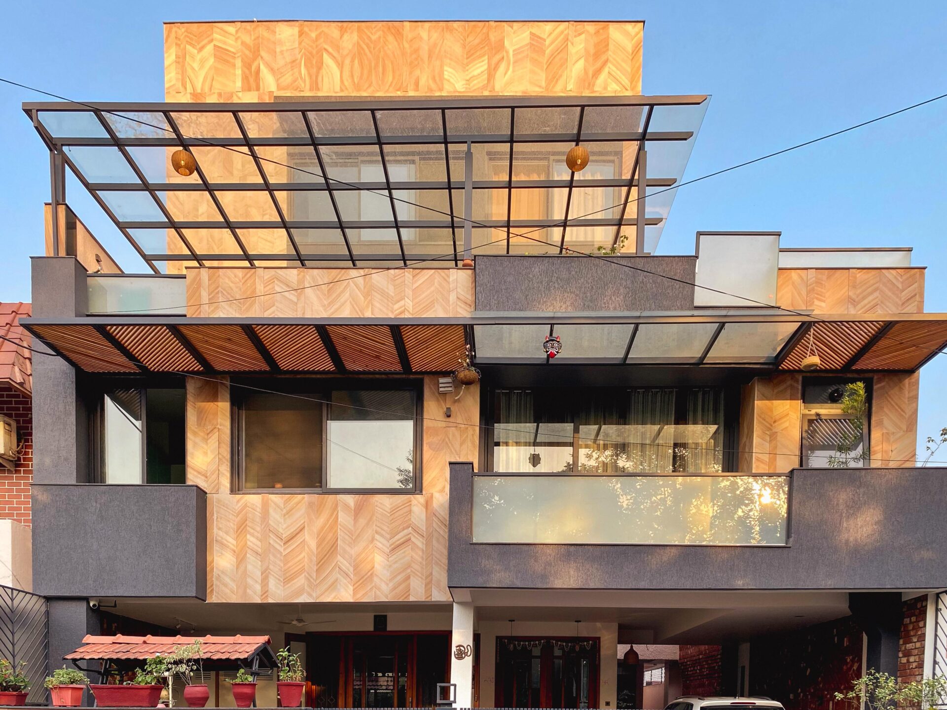 The exterior facade is characterized by layered balconies and a restrained material palette that expresses modern domestic architecture.