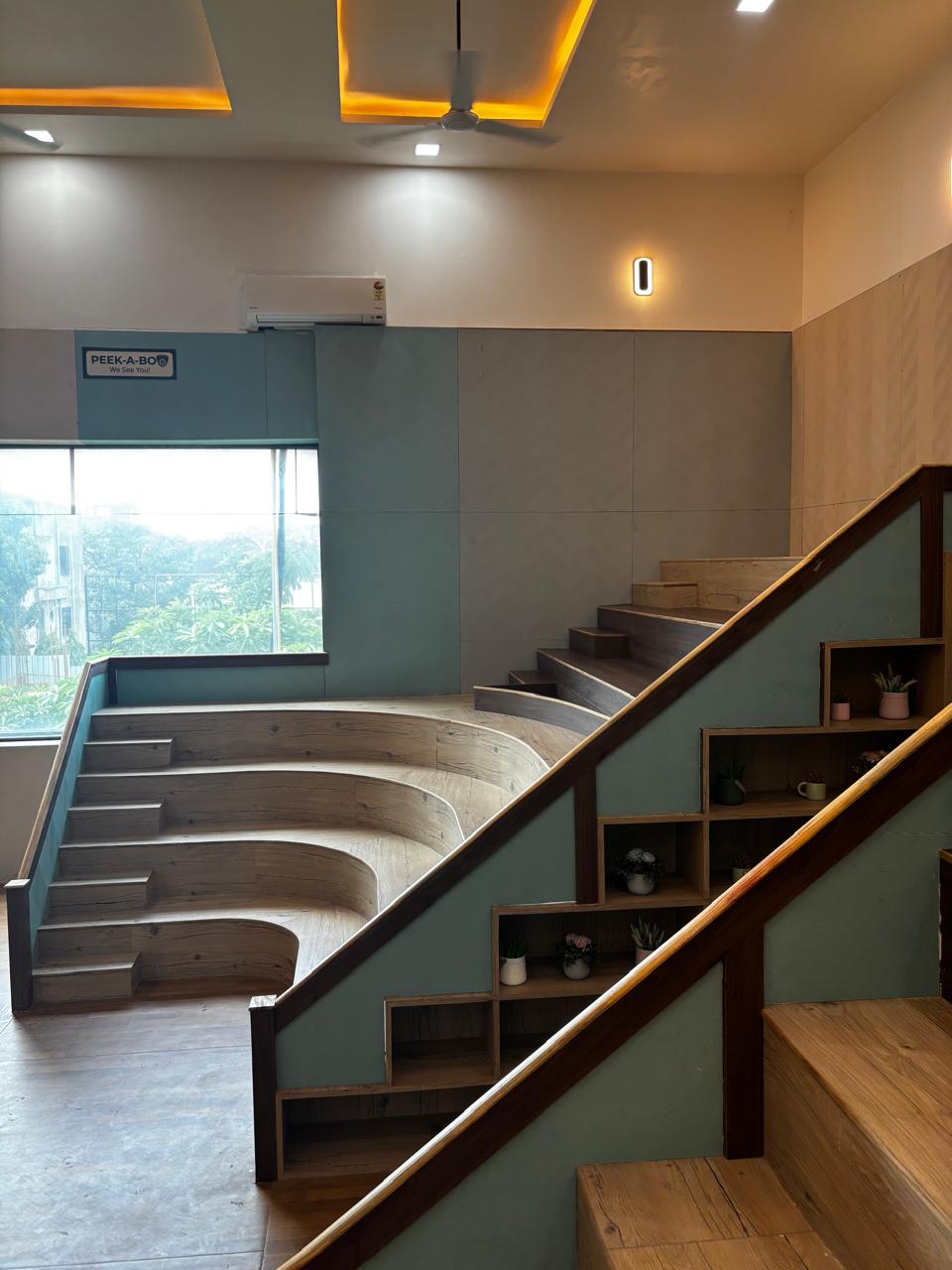 teps for gathering: This innovative staircase design integrates tiered, amphitheater-style seating, transforming a standard circulation area into a vibrant social hub for storytelling and group activities.