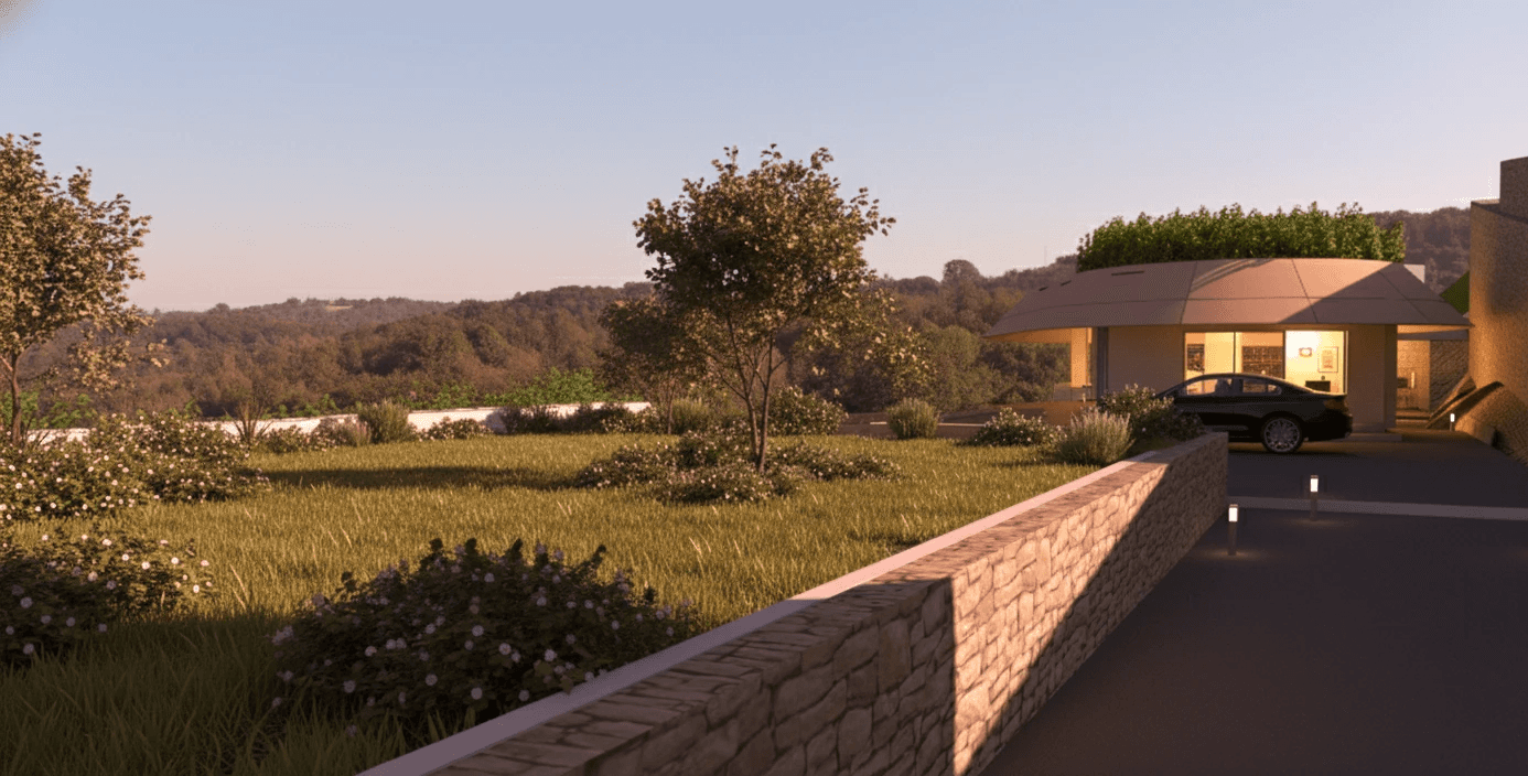 A scenic approach: A paved driveway lined with soft bollard lighting leads guests along the stone wall to the entrance, creating a sense of anticipation and arrival.