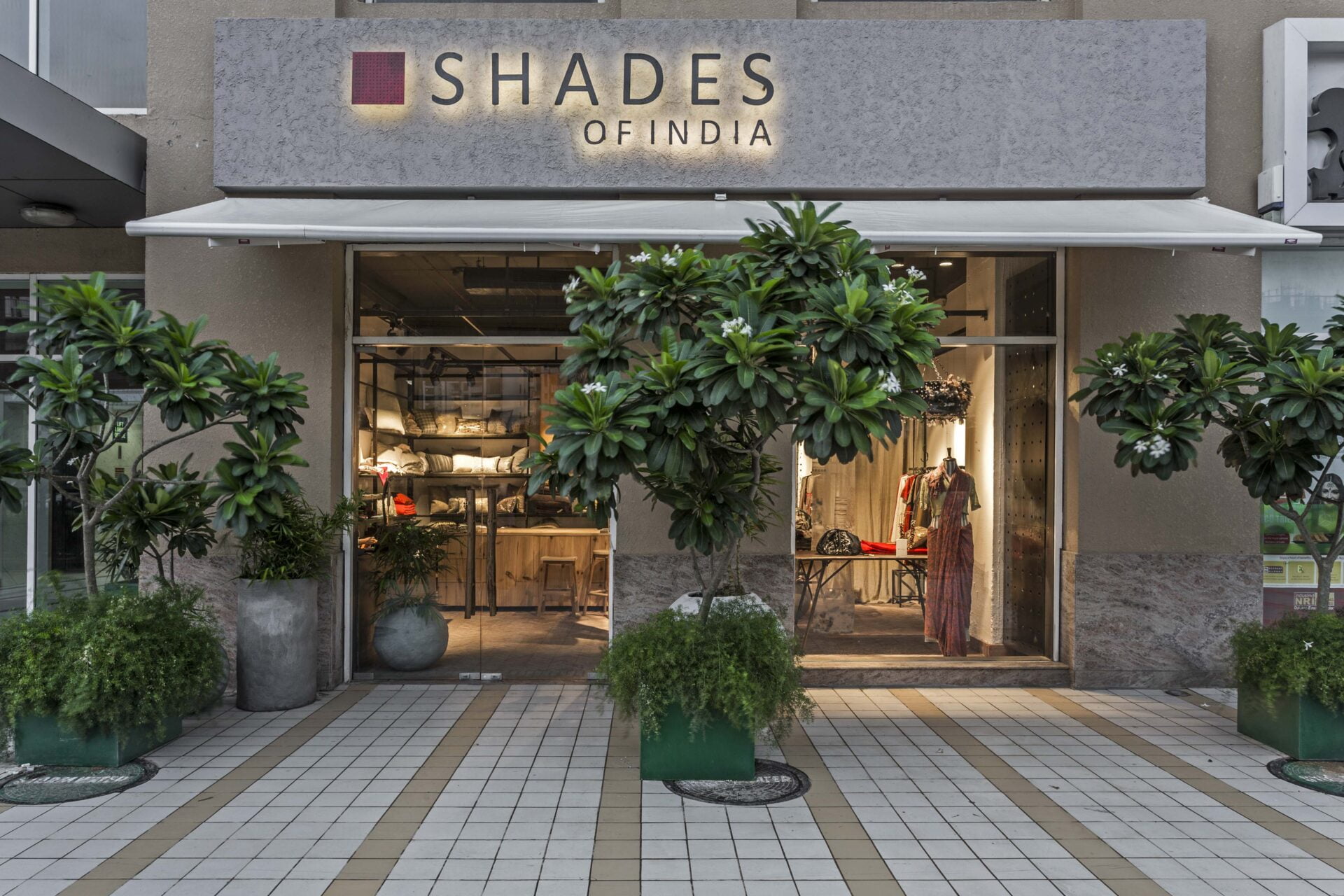 A transparent invitation: The glass facade allows passersby a glimpse of the handcrafted textiles within, seamlessly connecting the exterior to the retail experience.