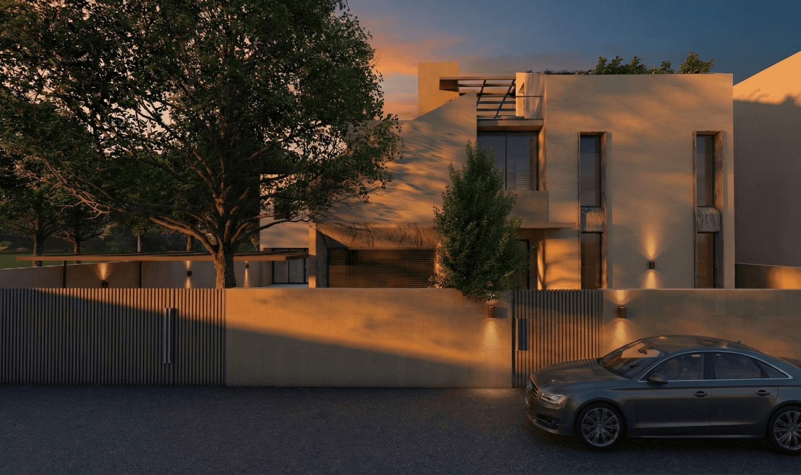 Twilight elegance: Wall sconces illuminate the textured perimeter while the architecture catches the last golden rays of the day, creating a welcoming arrival experience.